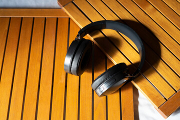 Music headphones on a wooden table.