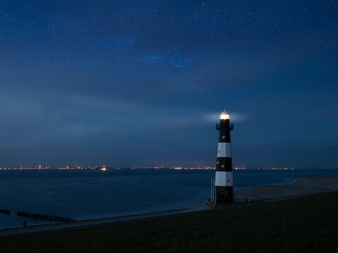 Lighthouse at night with stars