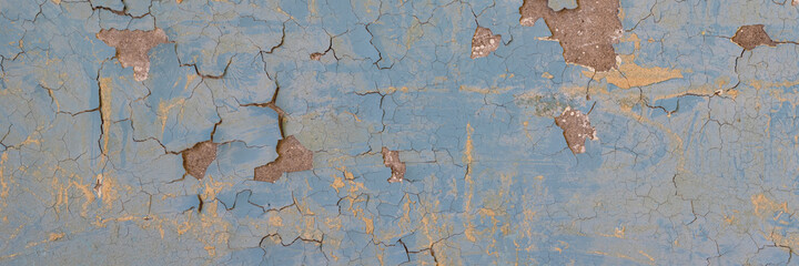 Peeling paint on the wall. Panorama of a concrete wall with old cracked flaking paint. Weathered...