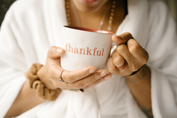 Woman drinking coffee at home in bed