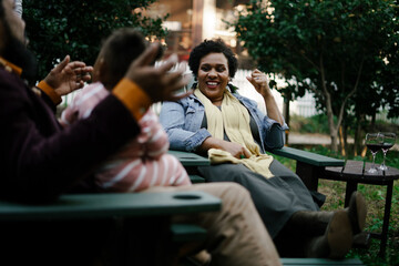 Black friends safely gathered and enjoying a backyard kickback party