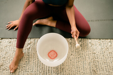 Woman using stress relieving singing bowl