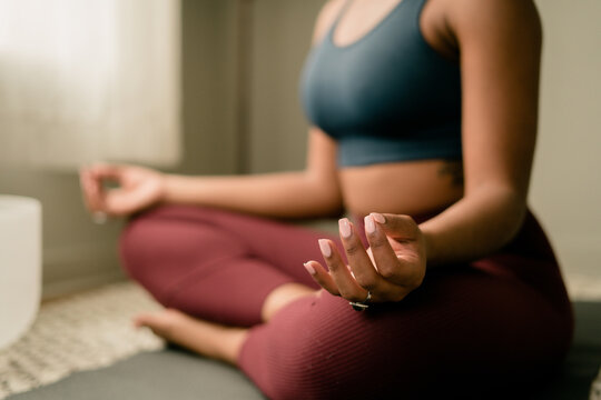 Young woman practices yoga at home