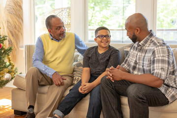 Multigenerational black men talking at home during Christmas