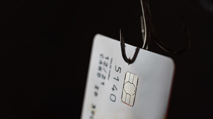 Close-up of a credit card on a fishing hook