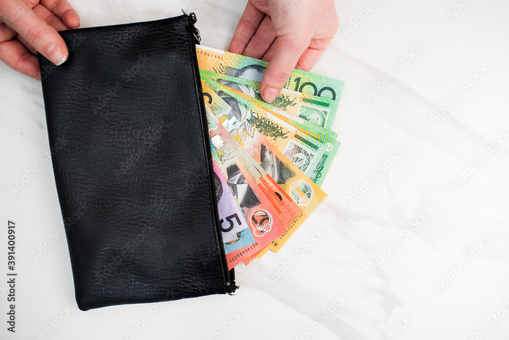 Sticker Australian dollar banknotes in a black wallet on the white background