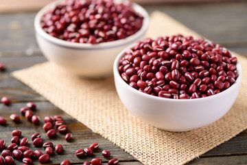 Azuki beans or red mung beans in a bowl on wooden table