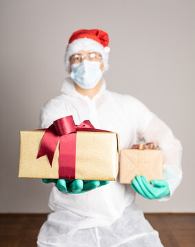 Man In Protective White Suit And Santa Claus Hat