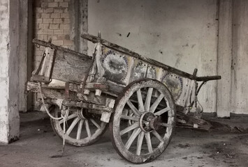 Fototapeta na wymiar Antico carro agricolo da buoi con pitture in stato di abbandono