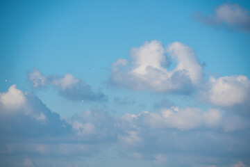 Blue sky background with white dramatic clouds and sunlight, sky background