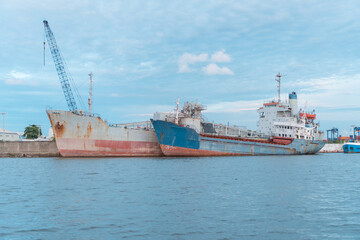 Rusty abandoned ships in the sea bay. Destroyed abandoned industrial ships.