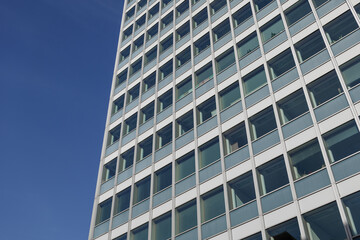 Low angle view of glass facade with rectangular windows frame structure system of modern style office building. Abstract Architectural Geometry elements. Mood of urban metropolis concept.