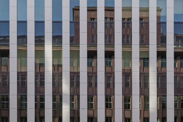 Background of exterior facade of modern building with detail of vertical stripe pattern with white...