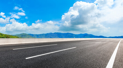 Fototapeta premium New asphalt road and green mountain with sky cloud natural landscape.