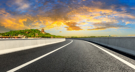 Empty asphalt road and the Summer Palace scenery in Beijing at sunset.