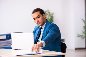 Young businessman employee sitting in the office