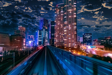 Fototapeta na wymiar Japan. Buildings and transport routes of Tokyo. Transportation of passengers by public transport. Evening in the Japanese capital. Evening city against the blue sky.