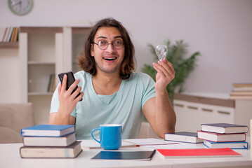 Young male student preparing for exams at home