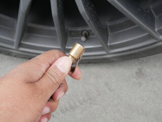 hand holding head pump air car machine for vehicle tires.