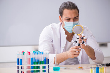 Young male chemist working in the lab