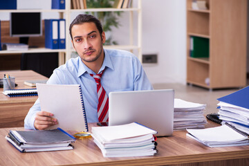 Naklejka premium Young male employee unhappy with excessive work