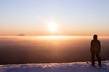 View of Mount Taranaki from Turoa Skifield, skier in background, winter season, New Zealand