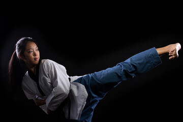TaeKwonDo Karate teenager athlete kick punch black background isolated
