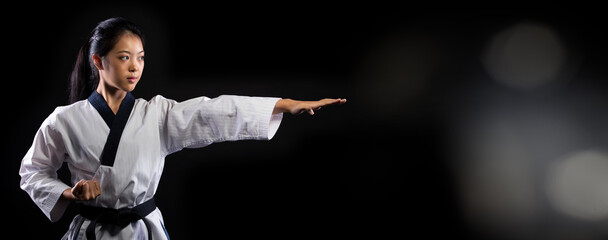 TaeKwonDo Karate teenager athlete kick punch black background isolated © Jade