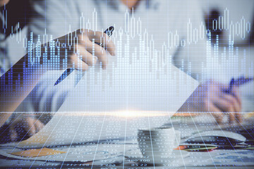 Double exposure of forex graph drawing over people taking notes background. Concept of financial analysis