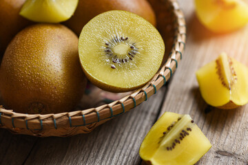 Kiwi slice on basket, close-up of yellow kiwi fruit