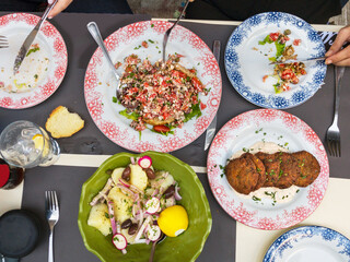 Greek mezedes and traditional salads on a table, Mediterranean food, top view.