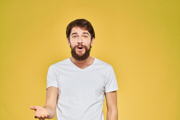Obraz premium Bearded man in white t-shirt emotions close-up fun yellow background