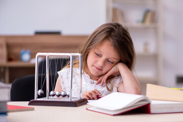 Small girl preparing for exams at home