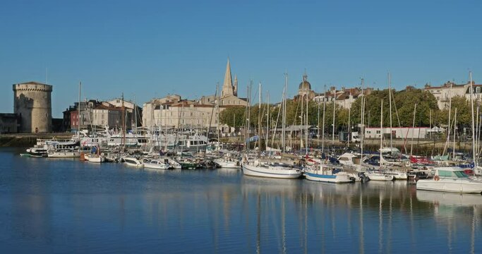 La Rochelle,Charente Maritime department, Region Nouvelle Aquitaine, France. View of the old harbour. On the right side is the Grosse Horloge tower, on the left side are the harbour towers.