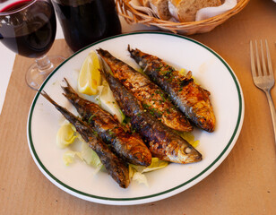 Fried sardines with lemon and parsley clodeup