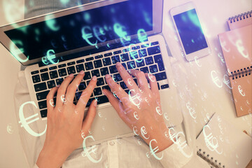 Plakat Double exposure of woman hands working on computer and forex chart hologram drawing. Top View. Financial analysis concept.