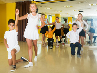Portrait of happy young children enjoying of partner dance in class