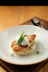 Steamed rice with roasted chicken fillet, close up on a wide plate, restaurant serving