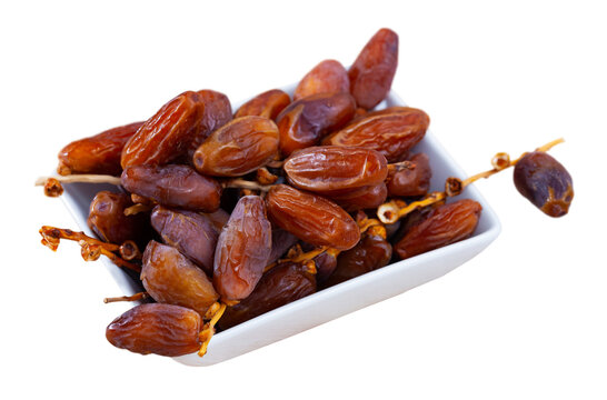 Tasty dried date close up, traditional mediterranean fruit. Isolated over white background