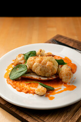 Dietary healthy dinner in a restaurant: grilled chicken breast with cauliflower cabbage, close up