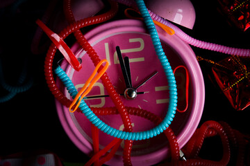 Pink alarm clock with colorful knick-knacks