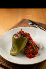 Close up of ready made stuffed bell-pepper with tomato sauce, restaurant serving