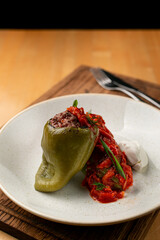 Close up of ready made stuffed bell-pepper with tomato sauce, restaurant serving