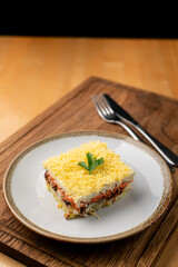 Mimosa salad with boiled vegetables and canned fish, as a traditional russian festive meal