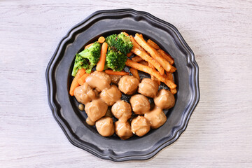 Chicken meatballs in creamy sauce on a plate  