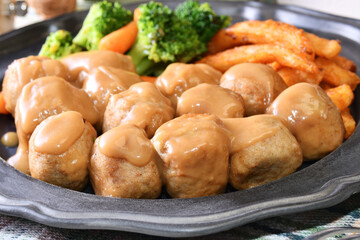 Chicken meatballs in creamy sauce on a plate  