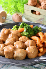 Chicken meatballs in creamy sauce on a plate  