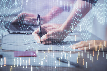 Multi exposure of woman hands typing on computer and financial chart hologram drawing. Stock market analysis concept.