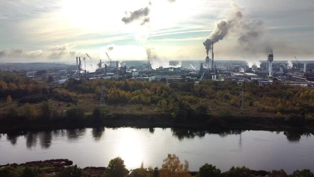 Aerial view of industrial area with chemical plant. Smoking chimney from factory. Chemistry factory in Lithunia, Achema. Production, industrial. Drone moving aerial shot.