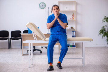 Young male doctor being unhappy after night shift